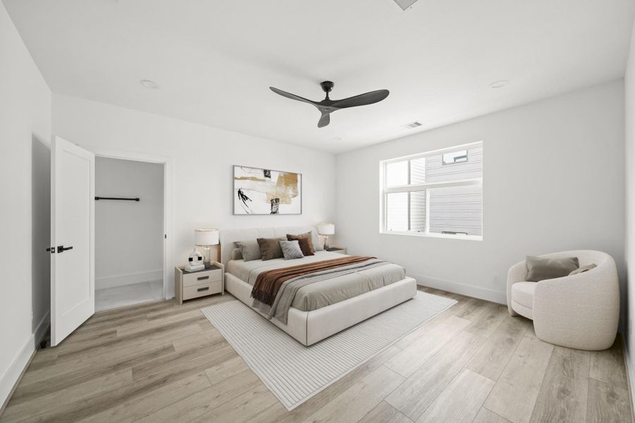 The 16’ x 15’ primary suite is a private retreat featuring luxury vinyl floor, tall baseboards and an oversized window that fills the room with natural light. This photo has been virtually staged. The 16’ x 15’ primary suite is a private retreat featuring luxury vinyl floor, tall baseboards and an oversized window that fills the room with natural light. This photo has been virtually staged.