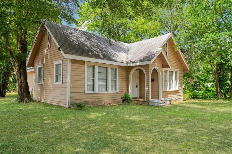 View of front of house with a front yard and a shingled roof View of front of house with a front yard and a shingled roof