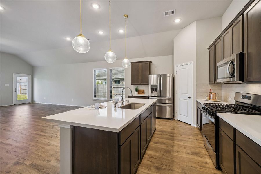 42 inch cabinets provide spacious storage room for all your dishes and cookware. The lighting is abundant; there is recessed lighting as well as beautiful pendant lights over the huge island.
