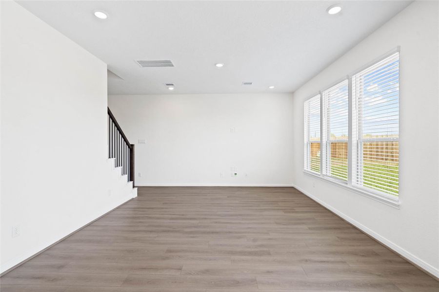 This bright and airy Great Room offers a spacious layout ideal for both relaxing evenings and lively gatherings. Designed for comfort and connection, it features Layton Lake vinyl plank flooring, large windows with blinds, high ceilings, recessed lighting, and seamless access to the stunning kitchen and dining—perfect for everyday living and entertaining alike. This bright and airy Great Room offers a spacious layout ideal for both relaxing evenings and lively gatherings. Designed for comfort and connection, it features Layton Lake vinyl plank flooring, large windows with blinds, high ceilings, recessed lighting, and seamless access to the stunning kitchen and dining—perfect for everyday living and entertaining alike.