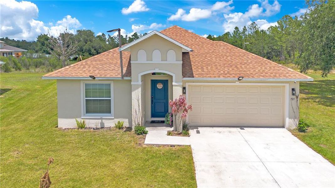Front exterior of a new home in , Poinciana, FL, highlighting curb appeal (Image 20). Front exterior of a new home in , Poinciana, FL, highlighting curb appeal (Image 20).