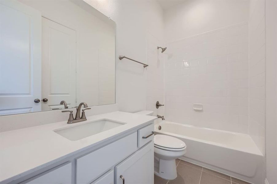 Full bathroom with toilet, shower / washtub combination, vanity, and tile patterned flooring