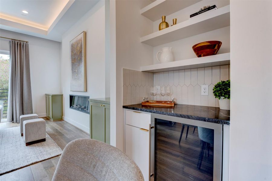 Beautiful built-ins and a large, separate wine fridge add a touch of luxury and sophistication to this property, offering both practicality and an appealing aesthetic.