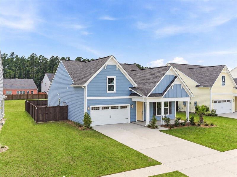 Front exterior of a new home in Homecoming, Ravenel, SC, highlighting curb appeal (Image 2). Front exterior of a new home in Homecoming, Ravenel, SC, highlighting curb appeal (Image 2).