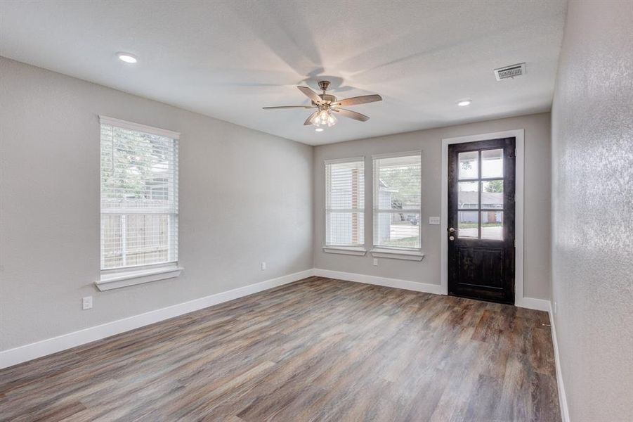 Foyer with a healthy amount of sunlight, hardwood / wood-style floors, and ceiling fan