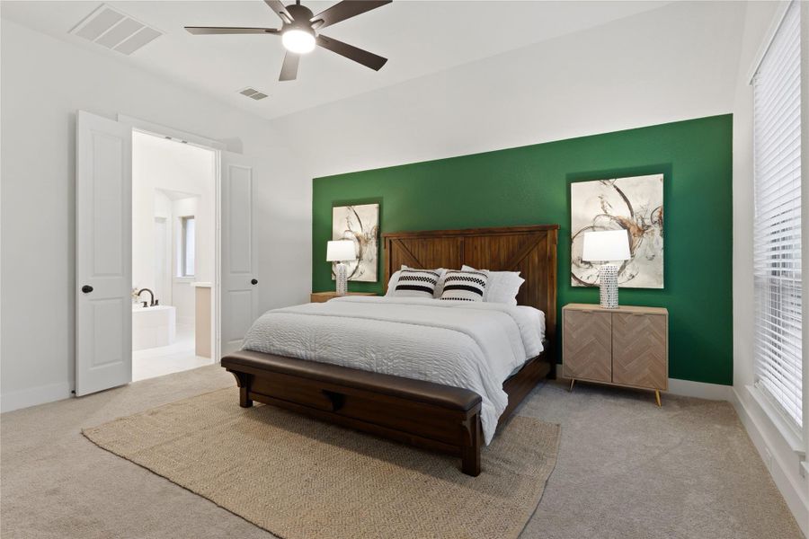 Spacious room featuring a deep green accent wall, recessed lighting, and a ceiling fan