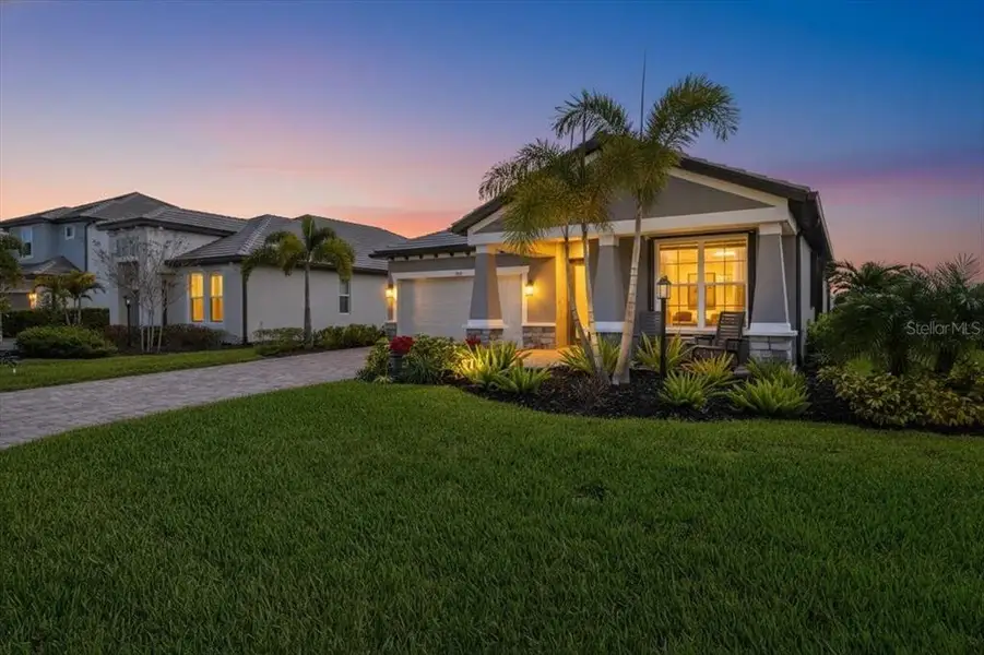 Front exterior of a new home in Cypress Glen at River Wilderness, Parrish, FL, highlighting curb appeal (Image 21).