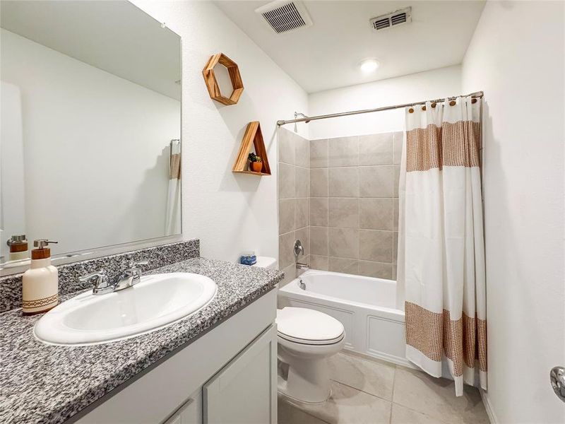 Bathroom featuring shower / bath combo with shower curtain and vanity