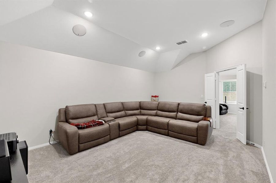 Living room with light carpet, vaulted ceiling, and recessed lighting Living room with light carpet, vaulted ceiling, and recessed lighting