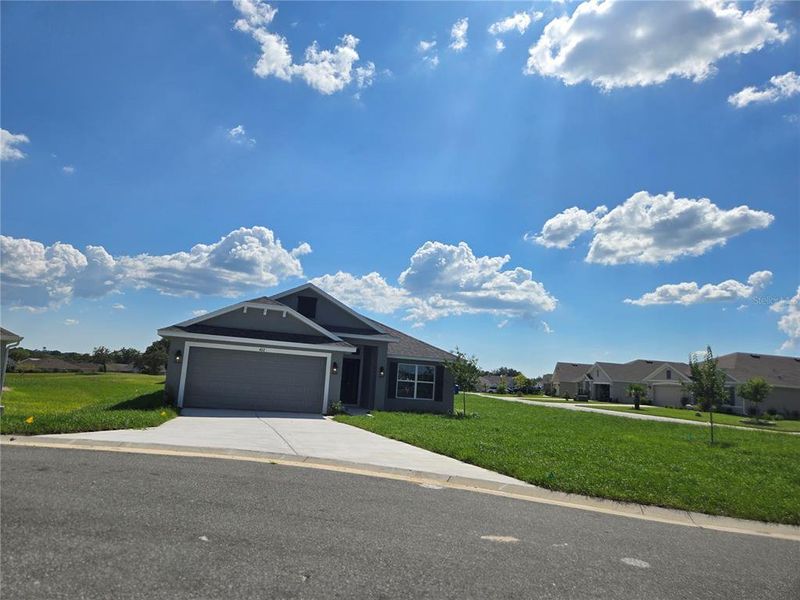 Front exterior of a new home in Twisted Oaks, Beverly Hills, FL, highlighting curb appeal (Image 23).