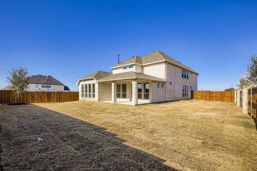 Back of property featuring a patio, a fenced backyard, and roof with shingles Back of property featuring a patio, a fenced backyard, and roof with shingles