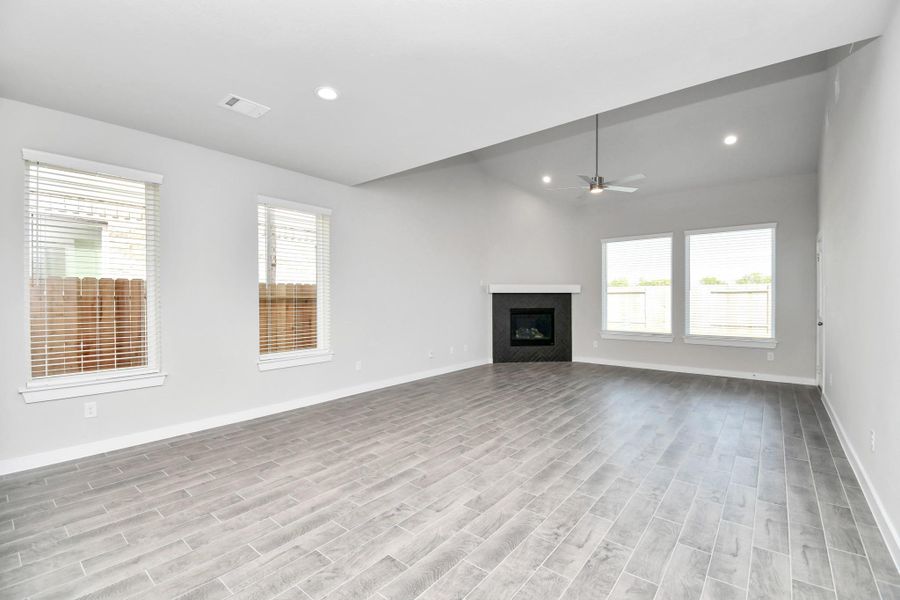 Welcome family and guests to your charming living room! With its high ceilings, recessed lighting, ceiling fan, custom paint, beautiful flooring, and large windows that let in abundant natural light, this room is perfect for gatherings. Welcome family and guests to your charming living room! With its high ceilings, recessed lighting, ceiling fan, custom paint, beautiful flooring, and large windows that let in abundant natural light, this room is perfect for gatherings.