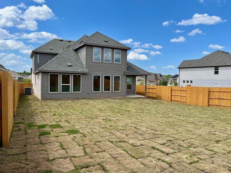 Back of house featuring roof with shingles and a fenced backyard Back of house featuring roof with shingles and a fenced backyard