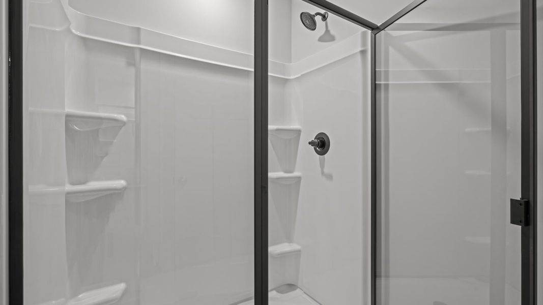 Superior en-suite primary bathroom with stylish dual vanity and walk-in shower crafted with high standards in mind Superior en-suite primary bathroom with stylish dual vanity and walk-in shower crafted with high standards in mind