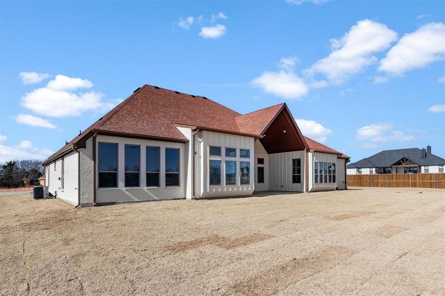 Rear view of property featuring large covered patio