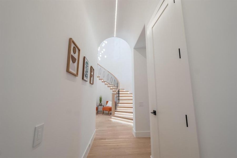 Corridor with light hardwood / wood-style flooring