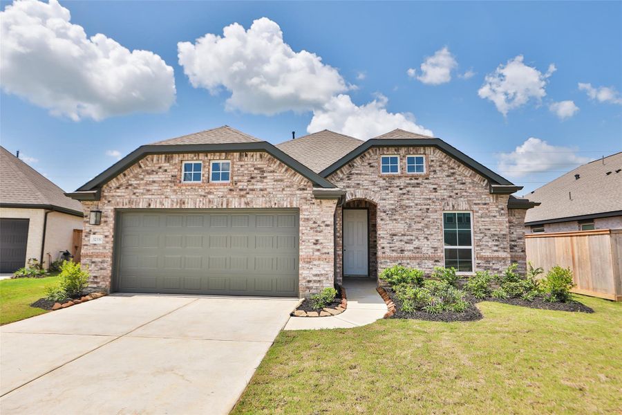 Front exterior of a new home in Oakwood Estates, Waller, TX, highlighting curb appeal (Image 23). Front exterior of a new home in Oakwood Estates, Waller, TX, highlighting curb appeal (Image 23).
