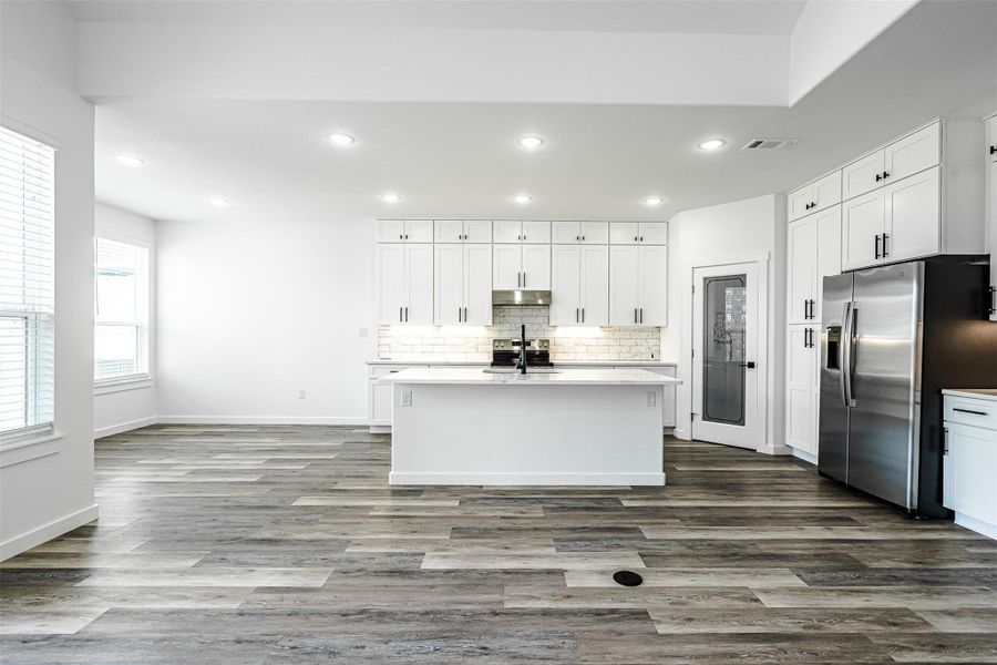 A well-appointed kitchen features a large central island and modern stainless steel appliances. A well-appointed kitchen features a large central island and modern stainless steel appliances.