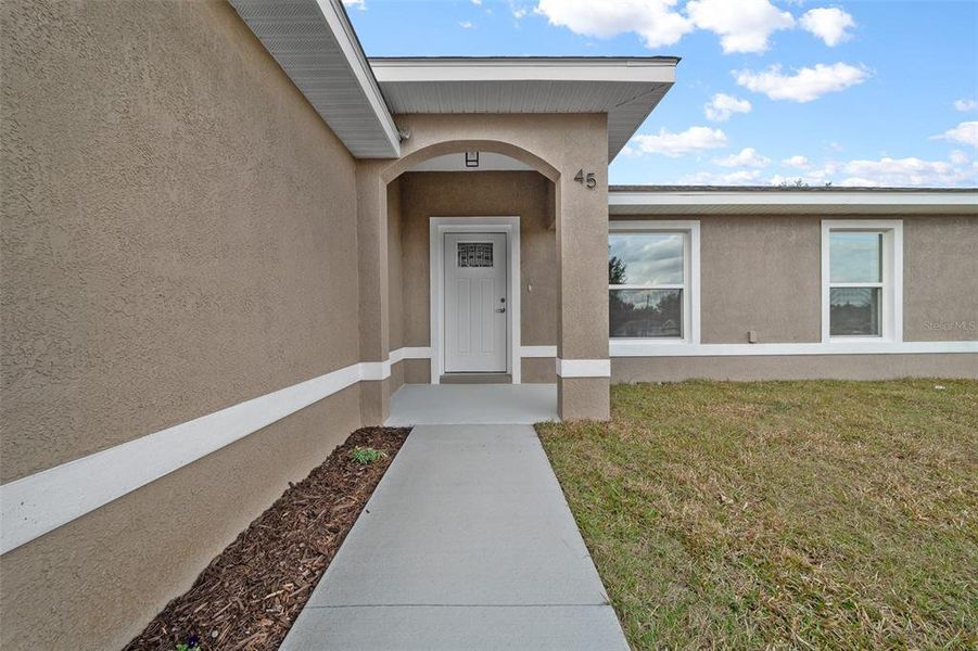 Front exterior of a new home in , Ocala, FL, highlighting curb appeal (Image 1).