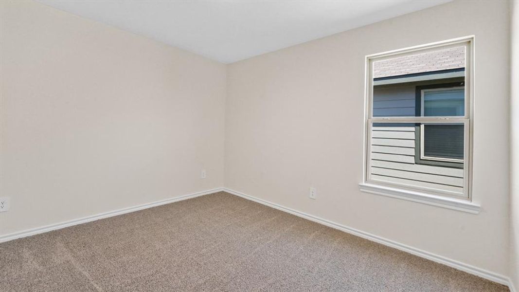 Neutral-toned walls complement plush carpet flooring