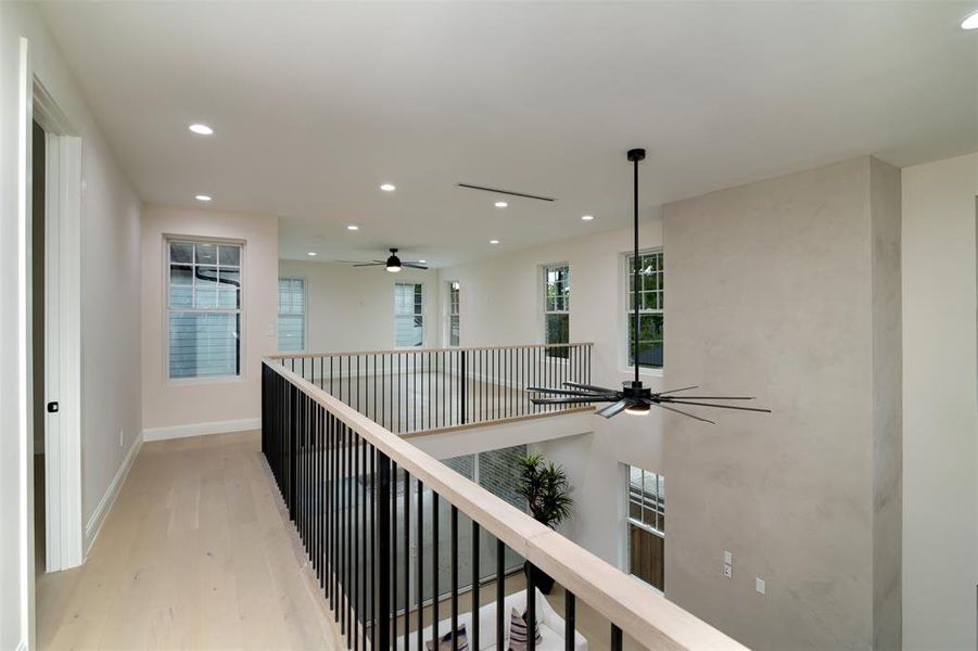 Hallway with light hardwood / wood-style flooring