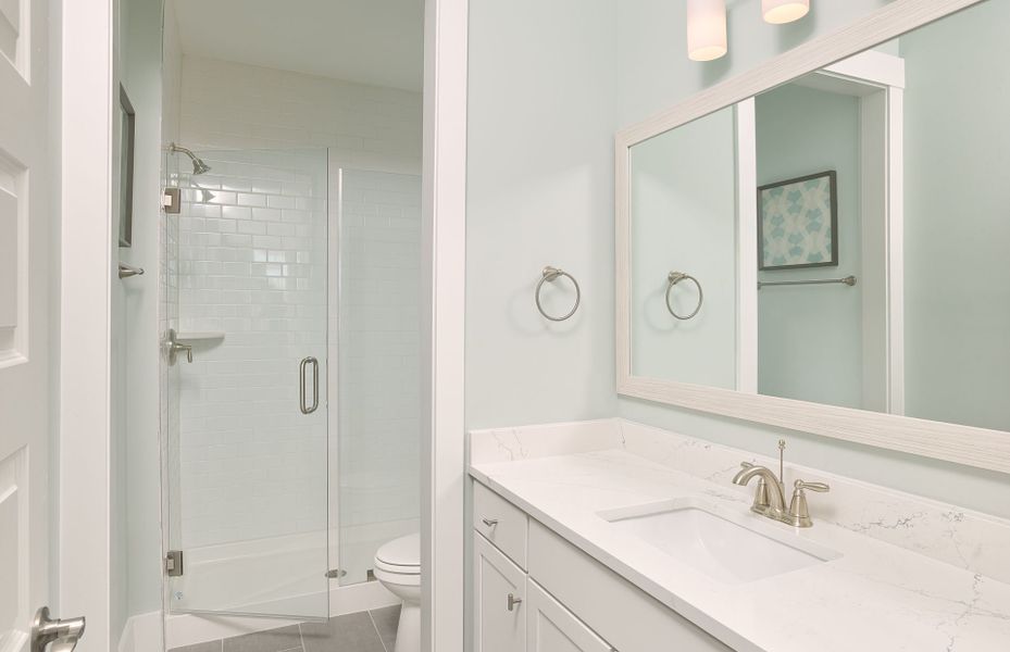 Secondary Bath with a frameless walk-in shower and a large frame mirror. Secondary Bath with a frameless walk-in shower and a large frame mirror.