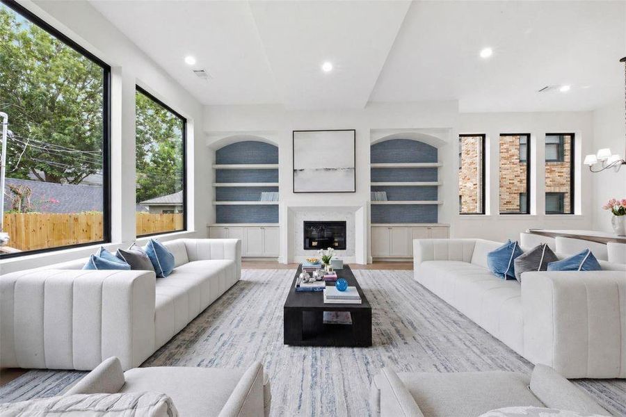 Living room with  oversized windows for views into yard