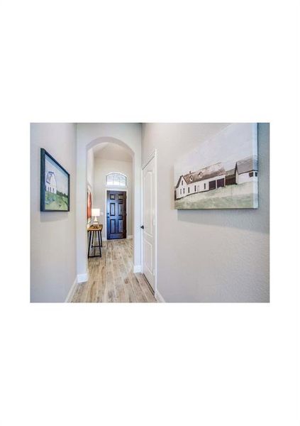 Corridor with light hardwood / wood-style floors