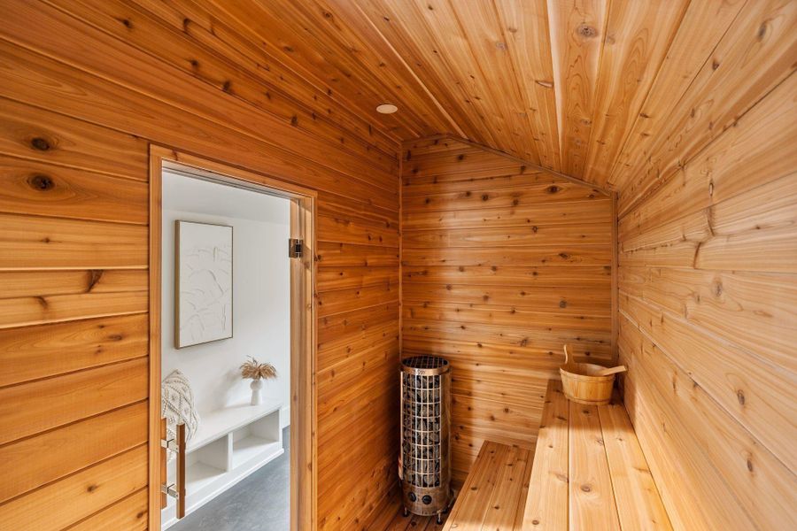 A retreat for relaxation, the sauna is beautifully clad in cedar, enhancing natural aroma and tactile warmth, with Harvia sauna stones utilized by the system to provide consistent heat and steam. A retreat for relaxation, the sauna is beautifully clad in cedar, enhancing natural aroma and tactile warmth, with Harvia sauna stones utilized by the system to provide consistent heat and steam.