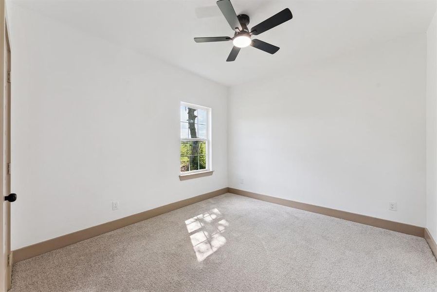 Unfurnished room featuring carpet floors and ceiling fan Unfurnished room featuring carpet floors and ceiling fan