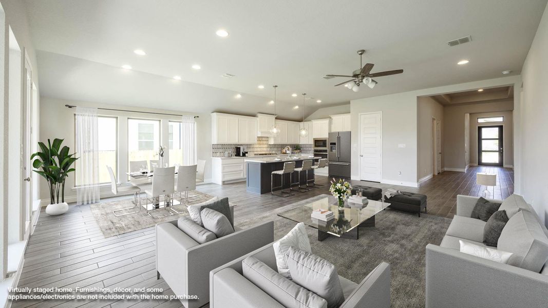 Living area featuring light wood-type flooring, visible vents, vaulted ceiling, a ceiling fan, and baseboards Living area featuring light wood-type flooring, visible vents, vaulted ceiling, a ceiling fan, and baseboards