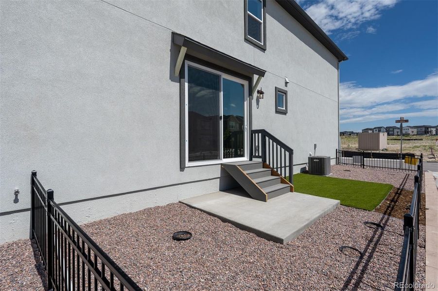 Front exterior of a new home in Revel Crossing at Wolf Ranch – The Ascent Collection, Colorado Springs, CO, highlighting curb appeal (Image 1).