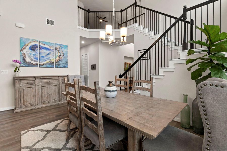 Dining area featuring high ceilings and wood-finish flooring