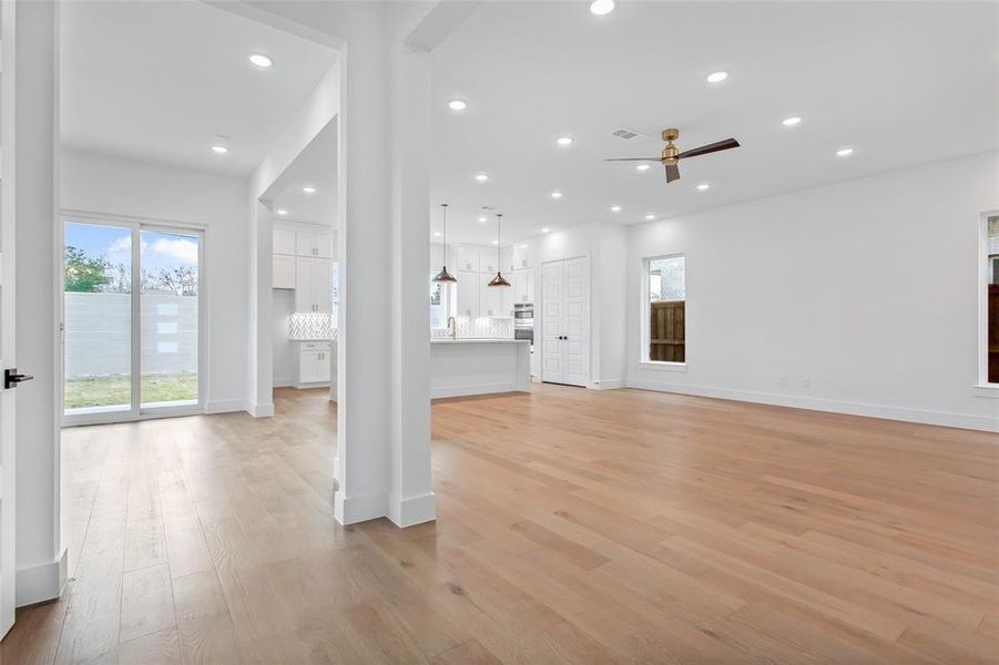 Unfurnished living room with light hardwood / wood-style floors, sink, and ceiling fan