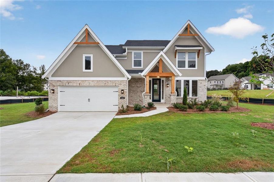 Front exterior of a new home in Hidden Fields, Hoschton, GA, highlighting curb appeal (Image 17). Front exterior of a new home in Hidden Fields, Hoschton, GA, highlighting curb appeal (Image 17).