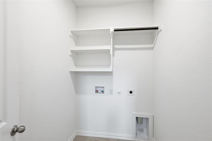 Washroom featuring hookup for a gas dryer, hookup for a washing machine, electric dryer hookup, and light tile patterned floors