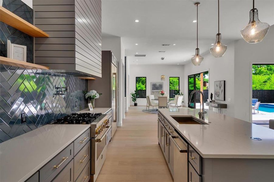 Kitchen with a healthy amount of sunlight, sink, pendant lighting, and stainless steel appliances