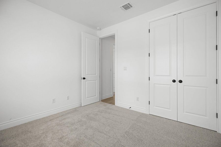 Unfurnished bedroom with carpet and a closet