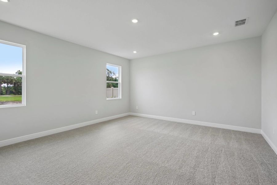 The primary bedroom is on the first floor located behind the kitchen