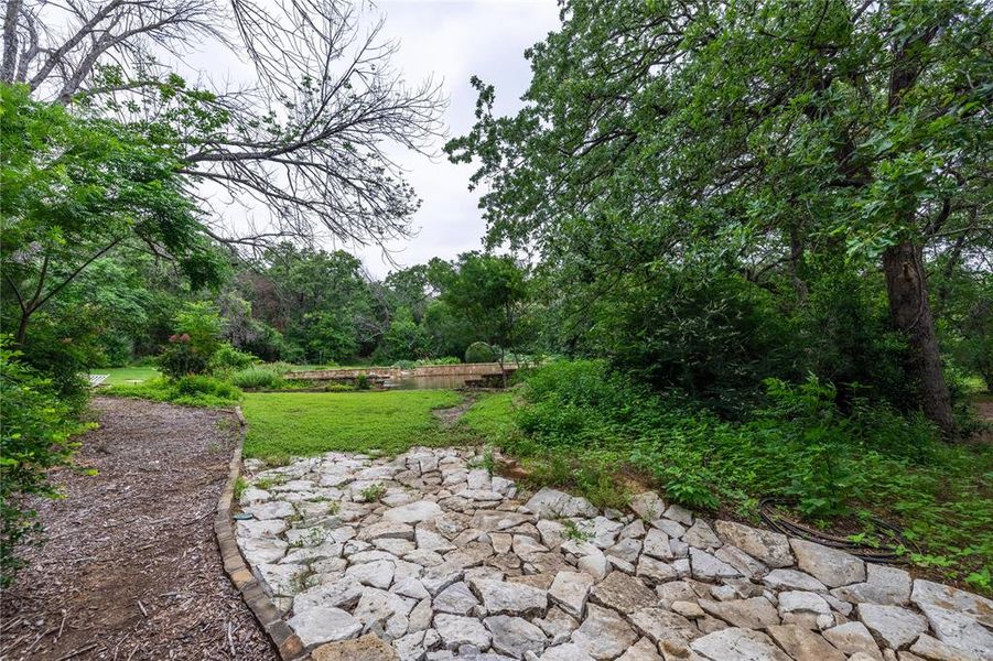 parklike setting leading to a large pond on this property