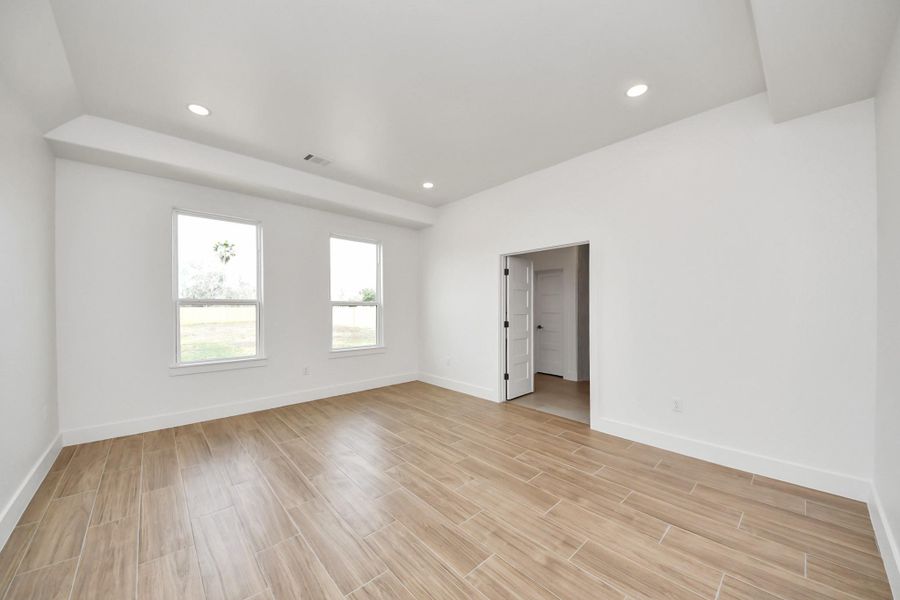 Another look at the primary bedroom, with tray ceilings