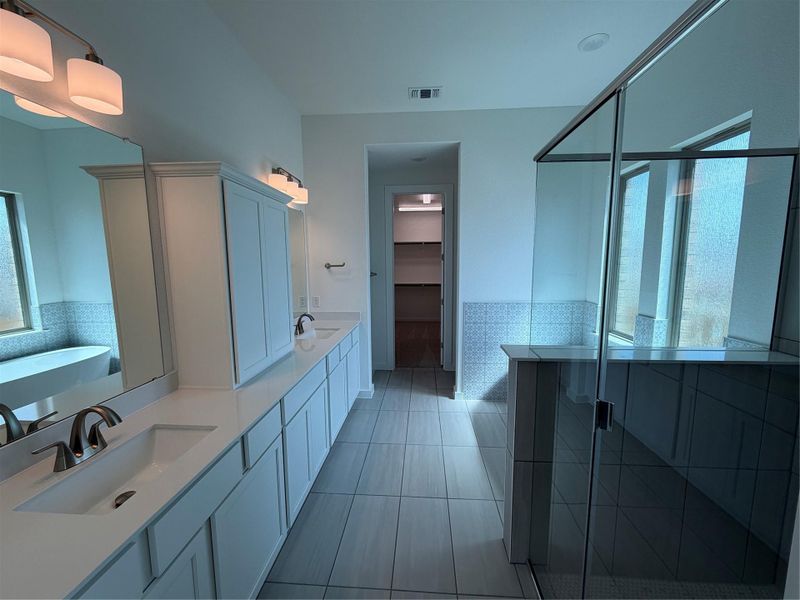 Primary Bath retreat with dual vanities, soaking tub & walk-in shower