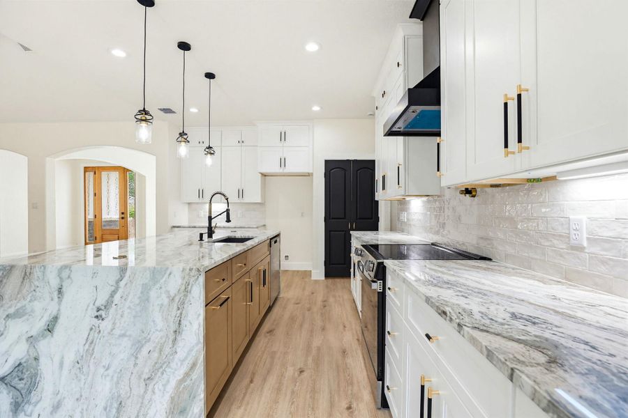 Culinary delights await in this bright kitchen, showcasing a spacious island, premium countertops.