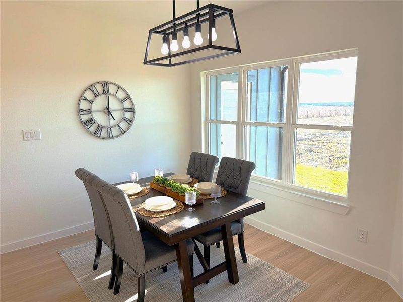 Dining space featuring light wood finished floors and baseboards