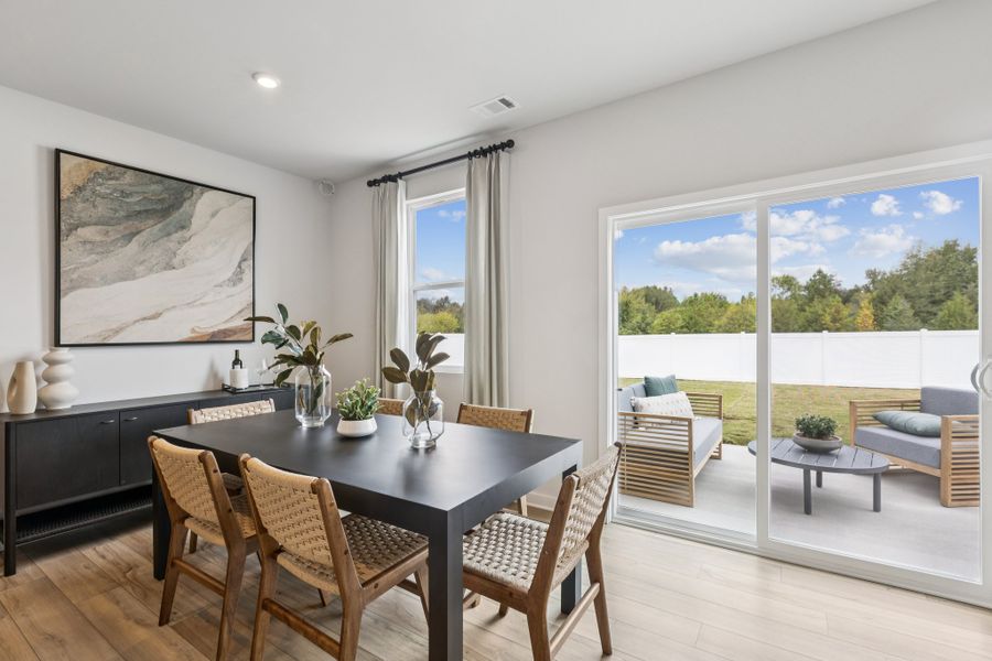 A dining room with a large window.