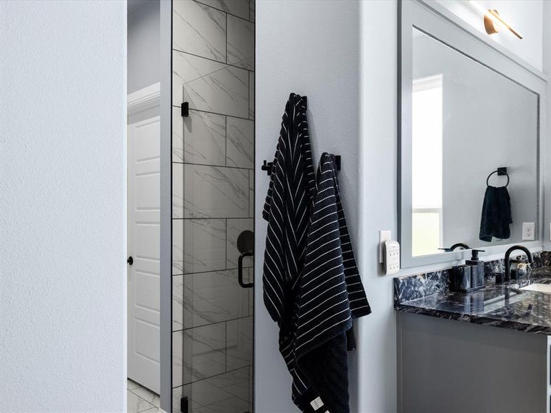 Bathroom featuring vanity and a stall shower Bathroom featuring vanity and a stall shower