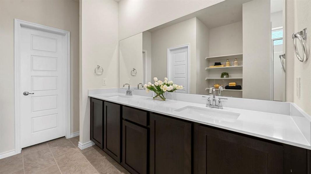 Bathroom with double vanity and light tile patterned floors Bathroom with double vanity and light tile patterned floors