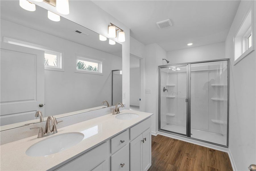 This spacious bathroom offers a double vanity and
