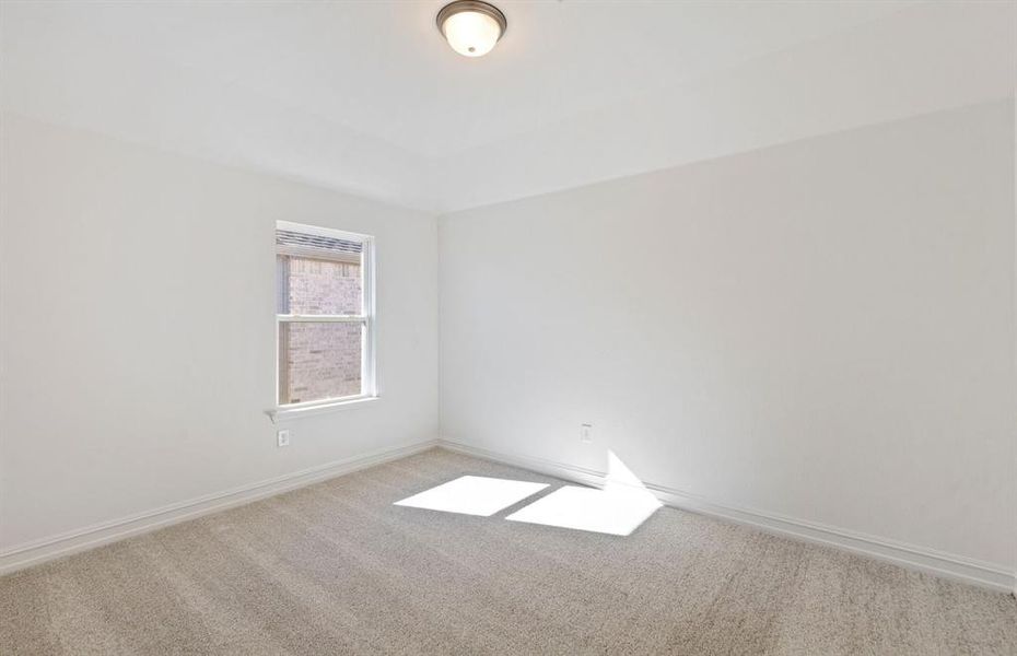 Spacious secondary bedroom with ample closet space  *real home pictured