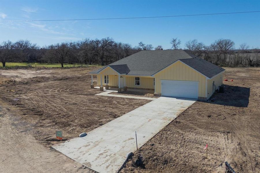 Ranch-style house featuring central AC unit and a garage